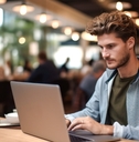 working on a laptop in a cafe