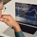 male investor reviewing crypto graphs