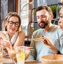 multi ethnic friends eating at restaurant