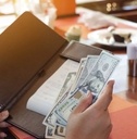 woman keeping tips in bill book