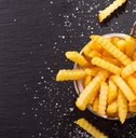 fries scattered on dark background 