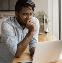 freelancer stands at kitchen desk