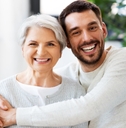 son smiling with mother at home