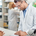 writing prescription at pharmacy