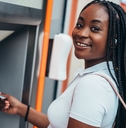 Smiling woman using ATM