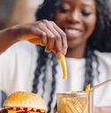 african american woman eating burger