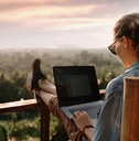 working at a laptop at sunset