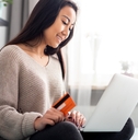 A young woman using a debit card