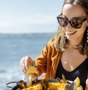 woman eating at ocean side restaurant