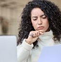 worried female accountant reviewing data