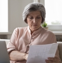senior woman reviewing taxes at home