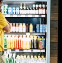 man besides drinks refrigerator