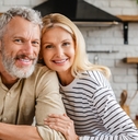 Middle-aged couple smiling at the camera