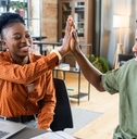 african american colleagues doing high five