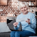female pensioner reviewing bills at home