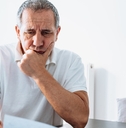 senior man reviewing bills at home