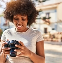 African American female photographer using camera