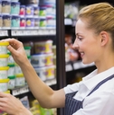 blonde worker keeping products in shelf