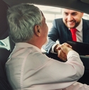 senior man buying car from dealer
