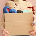 Woman holding box of unwanted stuff
