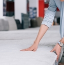 woman checking mattress in furniture shop