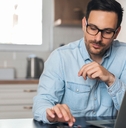accountant using calculator at home