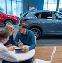 couple signs a contract for the purchase of a car