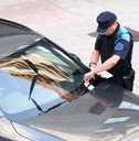 police writing parking ticket