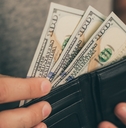 man looks in the wallet