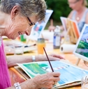senior woman smiling while drawing