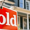 Sold Sign board outside Suburban Home