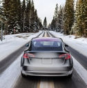 electric car driving mountains snow
