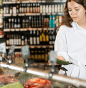 woman looking at vegetables in grocery store