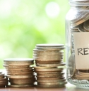 putting coins in glass jar