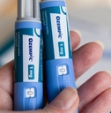 hand holding ozempic insulin