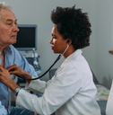 Female doctor examining senior patient