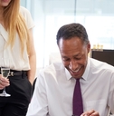 Coworkers celebrating colleague’s retirement in office