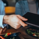 man paying bill with cash