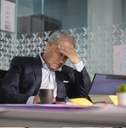 asian manager having headache at work
