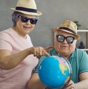 excited retired couple planning holiday trip