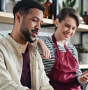 shop assitants using laptop at work