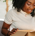 woman unpacking parcel cardboard box
