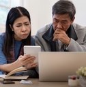 asian couple worried about bill
