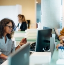 receptionist assisting people 