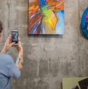 woman photographing painting