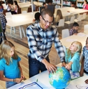 geography teacher teaching students in classroom
