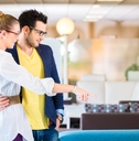 Couple buying couch in furniture store