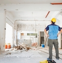 male worker inspecting house renovation