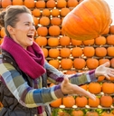 happy woman throwing pumpkin