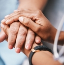 nurse holding hands with patient